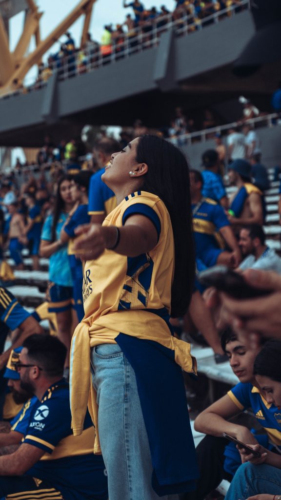 a women celebrating in a football stadium