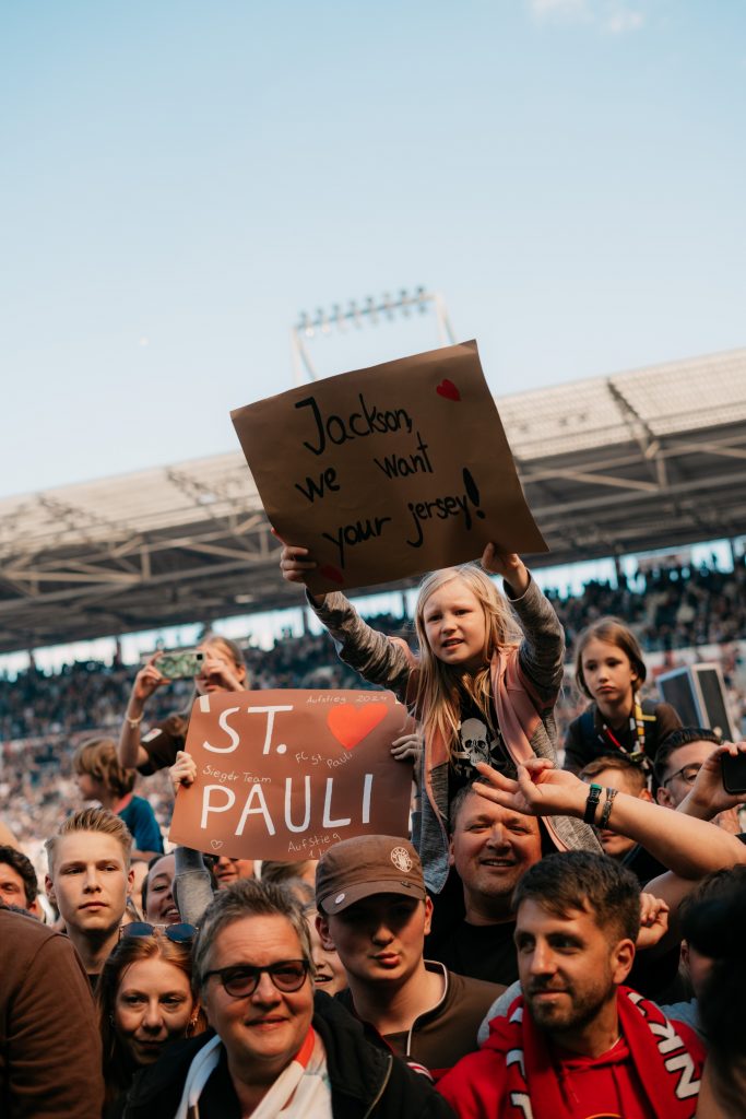 St. Pauli football fan holding a banner.