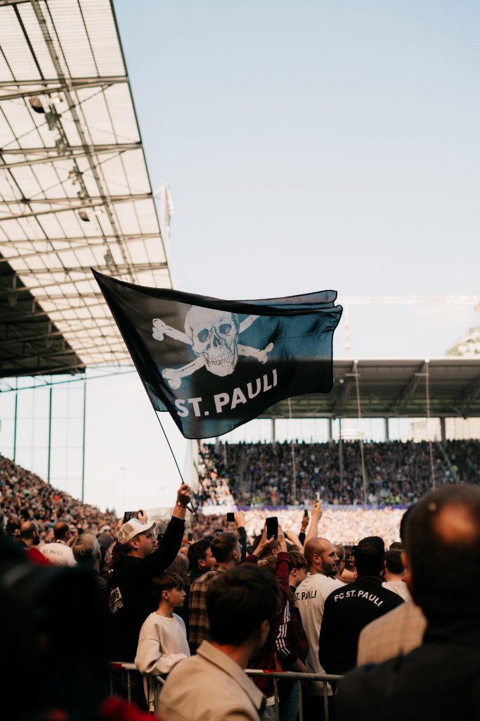 St. Pauli football fans holding flags.