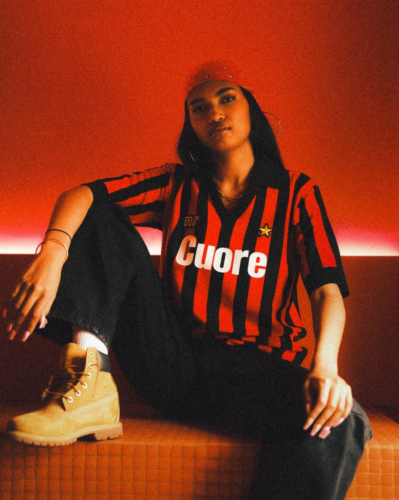 A woman wearing a red and black vintage football jersey.