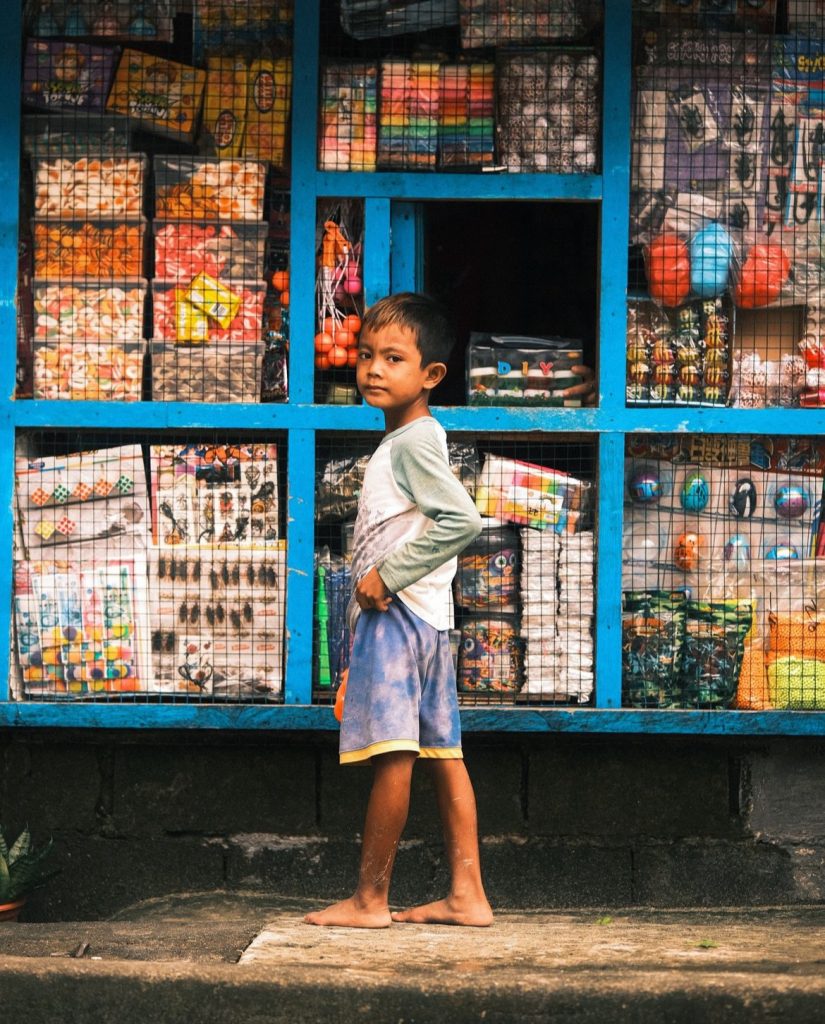 A young boy in the Philippines standing alone.