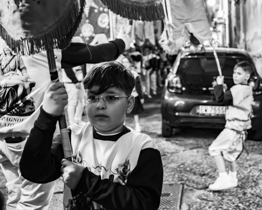 A child holding a flag at Festival of Madonna.